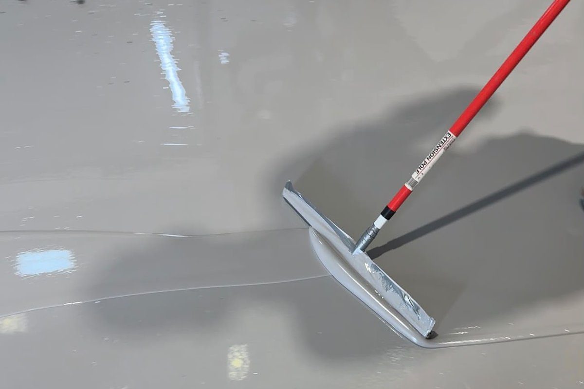 Epoxy resin being spread by squeegee during application